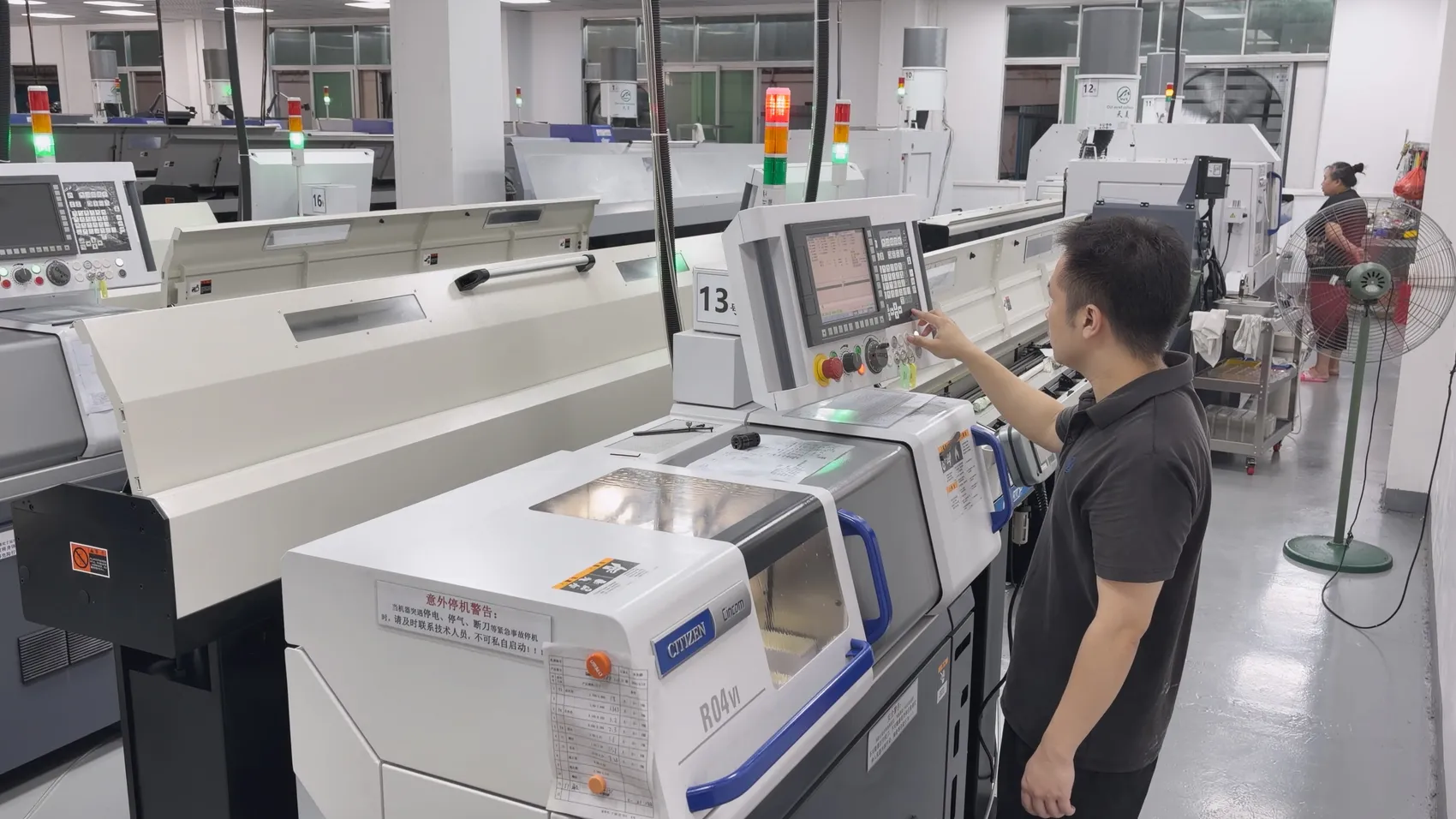 Machinist operating a Citizen Cincom R04VI Swiss-type CNC lathe on the OUJI production floor